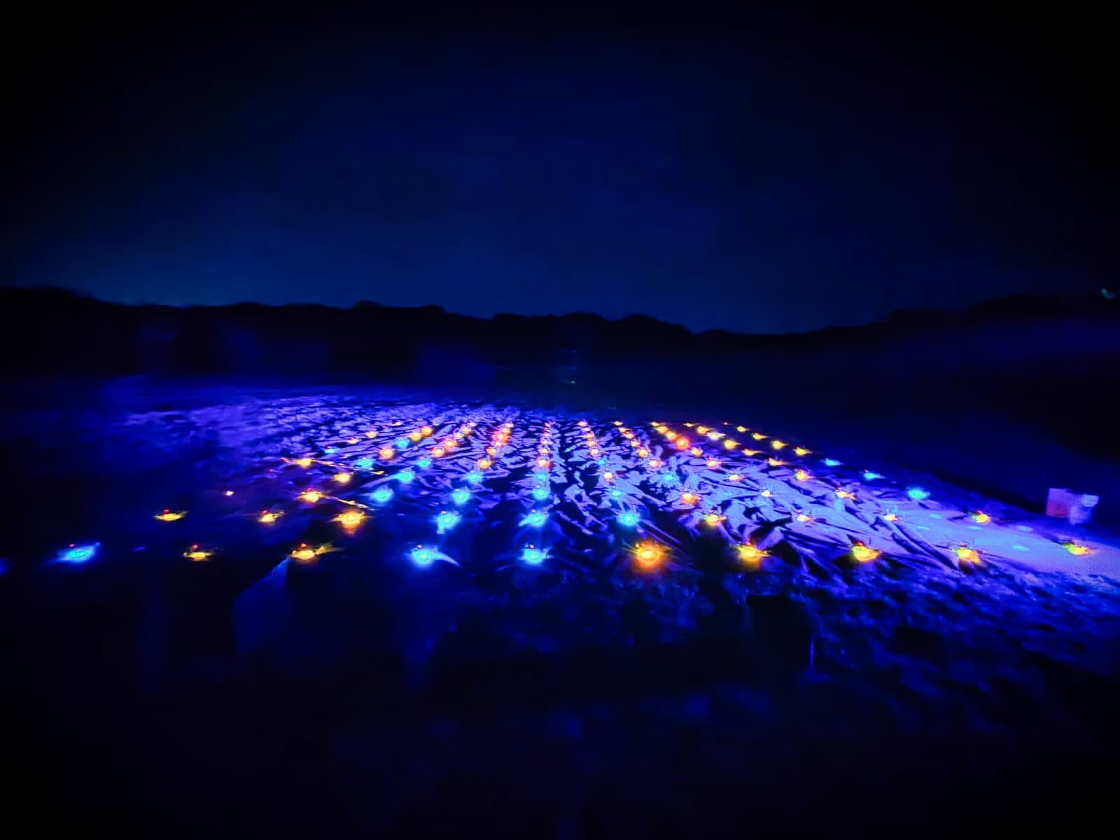 LED drones laid out on the ground before a UK drone light show